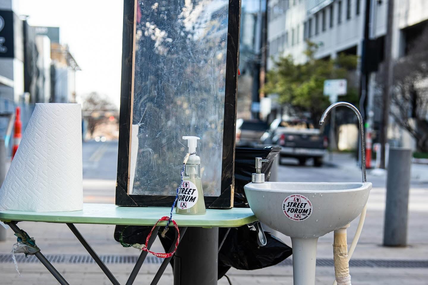 Portable hand-washing station with a Street Forum sticker